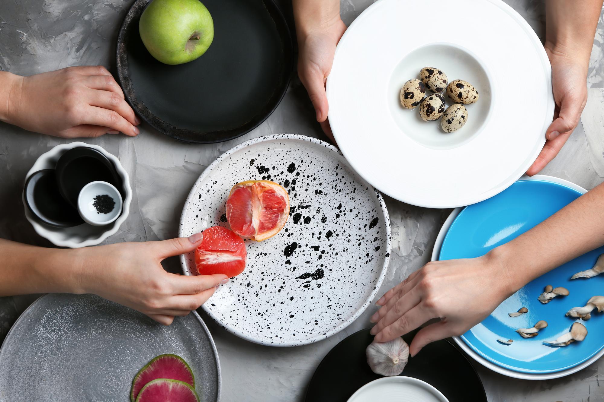 Team plating food in a bright studio